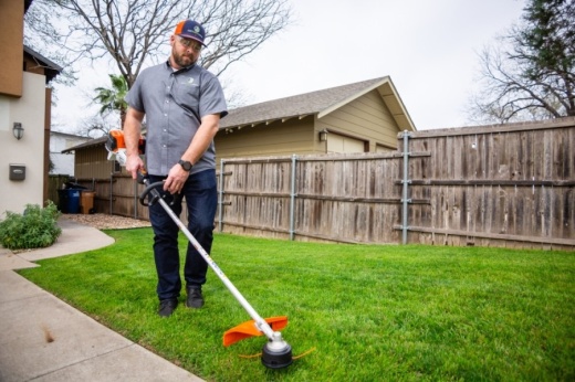 Just Right Lawn owner Jeremy Griffin weed whacks a lawn in South Austin. (Photos courtesy Just Right Lawns)