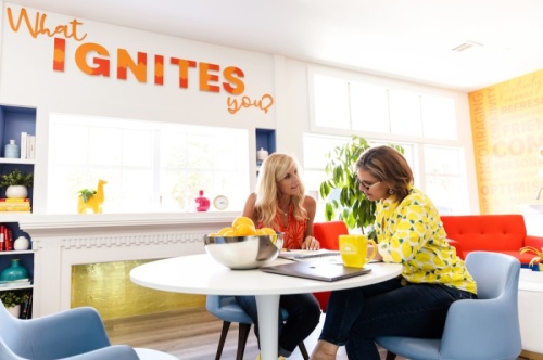 Claudia Beeny (right) sits in the community commons area of House of Shine's Grapevine digs. (Courtesy House of Shine)