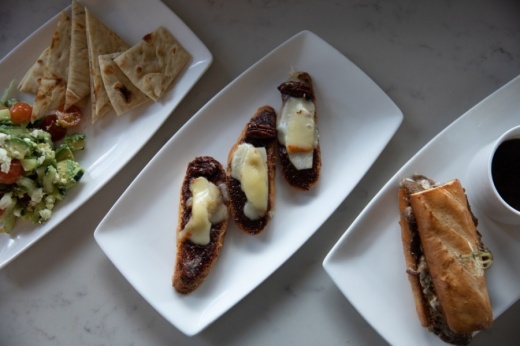 (Left to right) Among Edith's French Bistro menu offerings are the Almost Naked Salad (Small $7/Large $12), Brie and Fig Tartine ($8) and the French Dip ($9) sandwich. (Liesbeth Powers/Community Impact Newspaper)