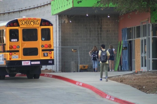 Students wearing masks enter Carroll Senior High School on Aug. 25 during the first week of classes. About 56% of the district’s students chose to receive in-person instruction. (Gavin Pugh/Community Impact Newspaper)
