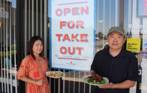 Laney Vo and Dinh Tran stand outside Hunan Chef, Cedar Park’s oldest Chinese restaurant. (Brian Perdue/Community Impact Newspaper)
