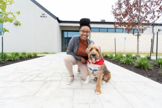 Shakkal Ware, Firehouse Pet Resort's resort supervisor, poses with Ganon. Firehouse Pet Resort is anticipated to open in Round Rock on Sept. 21. (Courtesy Daniel Crotty Photography)
