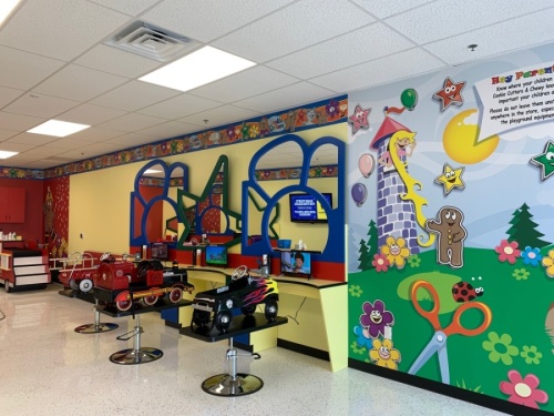 Children can sit in fantasy car salon booster seats and watch TV that show a variety of kids shows and games. (Cookie Cutters Haircuts for Kids)