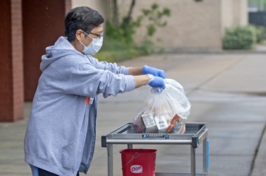 A Cy-Fair ISD employee distributes meals via curbside pickup for district students during the summer. (Courtesy Cy-Fair ISD)