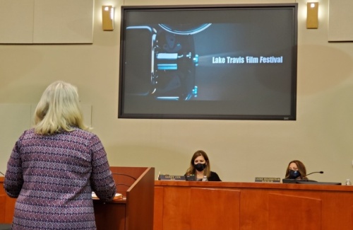 Kat Albert (left), the executive director of the Lake Travis Film Festival, delivers a presentation at the Oct. 19 Lakeway City Council meeting as Mayor Sandy Cox (center) and Mayor Pro Tem Laurie Higginbotham look on. (Brian Perdue/Community Impact Newspaper)