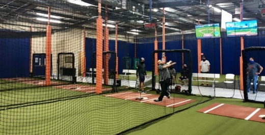 Dustin Geiger (right), a hitter who has played with the Chicago Cubs and Miami Marlins in the minor leagues, utilizes the center's data-gathering technology. (Sally Grace Holtgrieve/Community Impact Newspaper)