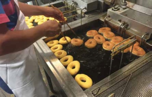The bakery is known for its Texas Sized Donut weighing 2 pounds and can trace its history back to 1926 when Reinhold R. Moehring opened the shop in downtown Round Rock. (Community Impact file photo courtesy Round Rock Donuts)