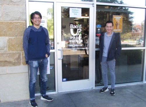 Alex Wu (left) and Kevin Tran stand, social distanced, outside of Bao'd Up in Sunset Valley. (Nicholas Cicale/Community Impact Newspaper)