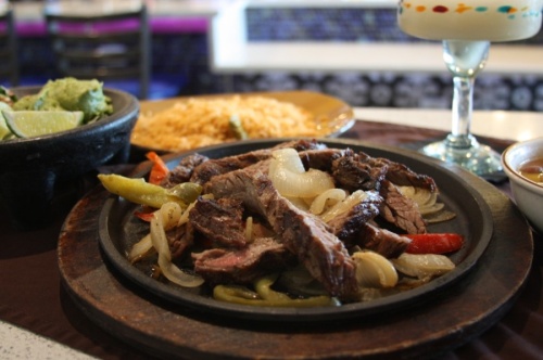 Sizzling Fajitas  st Adobe Cafe are $15.99 for one person and $28.99 for two people. (Lauren Canterberry/Community Impact Newspaper)