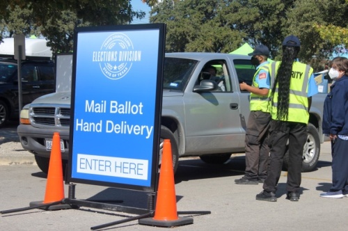 Travis County residents hand-deliver their ballots to election officials on Nov. 3. 