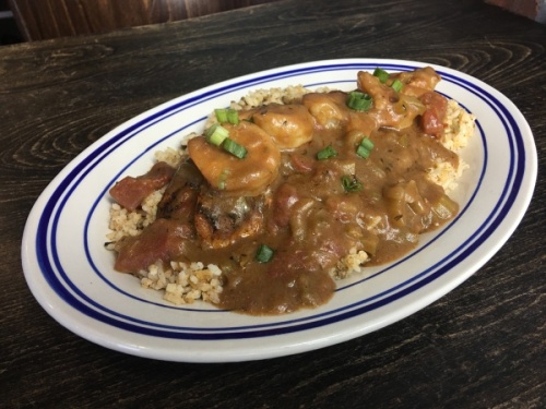 Lowens Trinity, $24.95: Grilled or blackened redfish on a bed of dirty rice topped with shrimp etouffee. (Haley Morrison/Community Impact Newspaper)