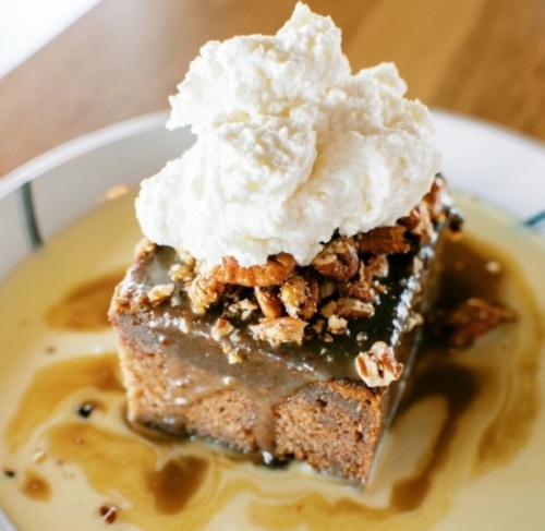 The namesake Whiskey Cake features a toffee torte topped with bourbon anglaise, spiced pecans and whipped cream. (Courtesy Whiskey Cake)