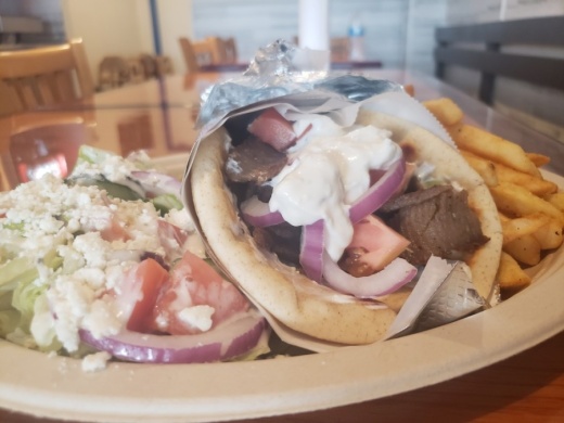 The gyro plate ($11.99) is served with Greek salad and fries. (Ali Linan/Community Impact Newspaper)