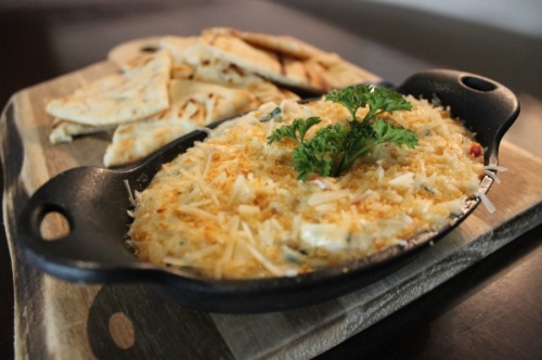 The hot crab and shrimp dip at Hillside Fine Grill is baked until bubbly, then served with pita bread. (Daniel Houston/Community Impact Newspaper)