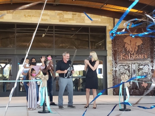 Kalahari Resorts & Conventions owner Todd Nelson, center, cut the ribbon for the new Round Rock resort Nov. 12. (Ali Linan/Community Impact Newspaper)
