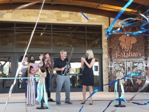 Kalahari Resorts & Conventions owner Todd Nelson (center) cuts the ribbon for the new Round Rock resort Nov. 12. (Ali Linan/Community Impact Newspaper)