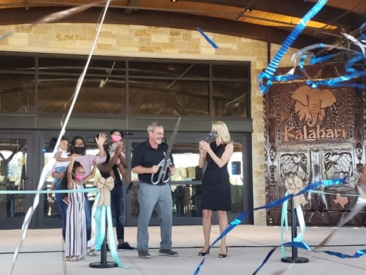 Kalahari Resorts & Conventions owner Todd Nelson (center) cuts the ribbon for the new Round Rock resort Nov. 12. (Ali Linan/Community Impact Newspaper)