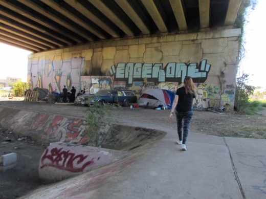 Allison Trotter, founder of Solid Ground Ministry, walks underneath Ben White Boulevard in South Austin. (Nicholas Cicale/Community Impact Newspaper)