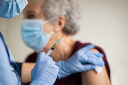 Photo of elderly woman receiving vaccine