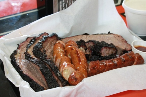 The Rusty Buckle BBQ Co. serves a plate with brisket, jalapeno cheese sausage, brisket burnt ends and black pepper sausage ($18). (Andy Li/Community Impact Newspaper)