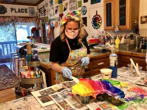 Art Barn ATX owner Amber Gordon uses resin on a project. (Sally Grace Holtgrieve/Community Impact Newspaper)