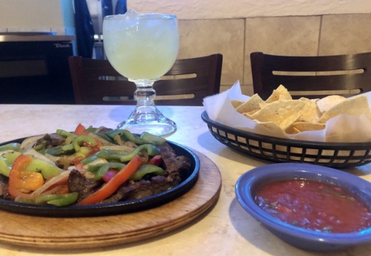 Steak fajitas are a popular menu item and are shown here with chips, salsa and a margarita. (Sally Grace Holtgrieve/Community Impact Newspaper)