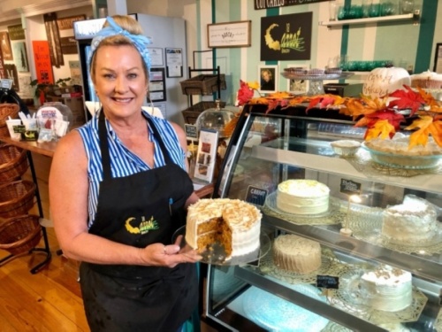 Shari Cahil, 18 Carrot Bakery's owner, poses with her signature carrot cake. (Sally Grace Holtgrieve/Community Impact Newspaper)