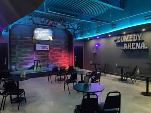 Comedy club with colored lights and socially distant seating