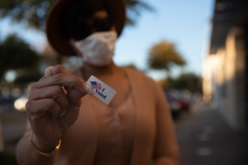 Woman holding I Voted sticker