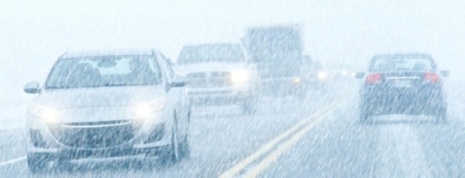 cars driving in snowy weather