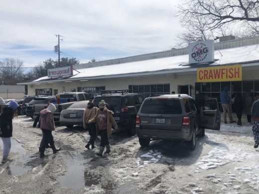 Residents of San Marcos walk to OMG Seafood in San Marcos to take advantage of the free food the restaurant was giving away all day Feb. 16. (Courtesy Joseph Daley)