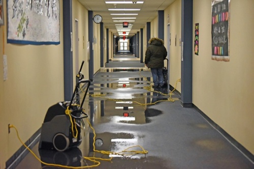 Restoration crews at Swenke Elementary School work to clean up water from the floors following freezing temperatures this week that caused pipe damage to campuses. (Courtesy Cy-Fair ISD)