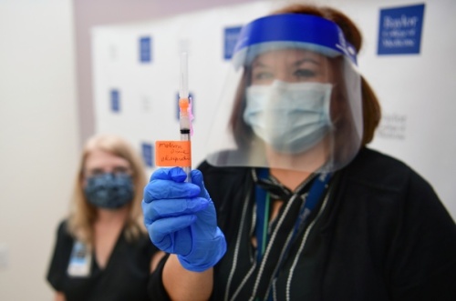 An health care worker with the Baylor College of Medicine holds up a Moderna vaccine. (Courtesy Baylor College of Medicine)