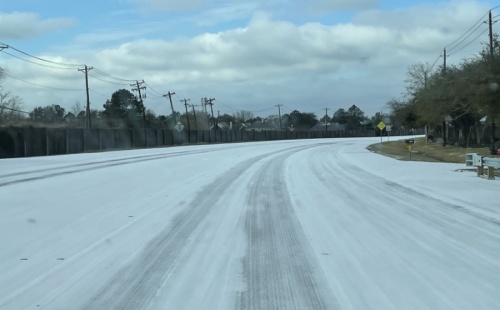 Parkwood Avenue in Friendswood saw a thin blanket of snow Feb. 15. Throughout the week, millions across the state, including in Pearland and Friendswood, experienced power outages, burst pipes and other problems as a result of the frigid temperatures. (Courtesy Alison Daniel)