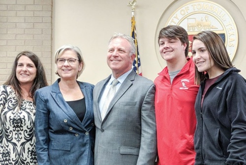 Rob Hauck (center) is pictured with Mayor Gretchen Fagan (second from left) and his family following his appointment as Tomball City Manager in 2018. (Anna Lotz/Community Impact Newspaper)