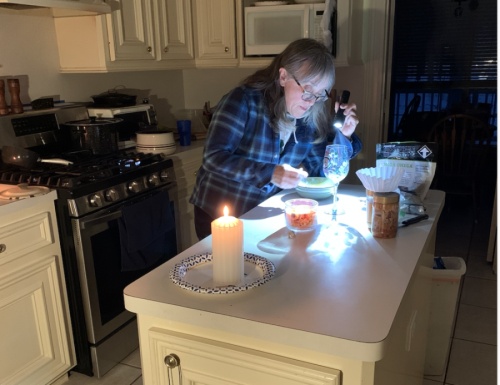 Betsy Stern, a resident of Sendera Ranch, uses a flashlight and candles during the February winter storm that left millions of Texans without power. Most of the Conroe, Montgomery and Willis areas are served by Entergy Texas, which lies outside the state grid. (Courtesy Betsy Stern)