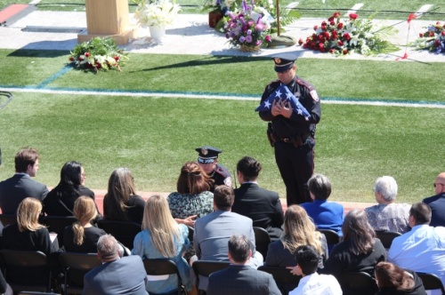 The Tomball Police Department presented two flags to the family of the late Rob Hauck during the March 19 memorial service. (Anna Lotz/Community Impact Newspaper)