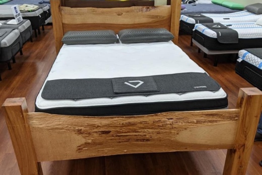 A mattress and bedframe in a store showroom