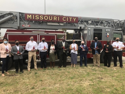 Missouri City City Council, along with other city leaders and project contractors, participated in a "rollout" ceremony March 24. (Claire Shoop/Community Impact Newspaper)