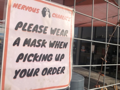 A sign at Nervous Charlie's bagel shop in north Central Austin reminds customers to wear a mask. (Jack Flagler/Community Impact Newspaper)
