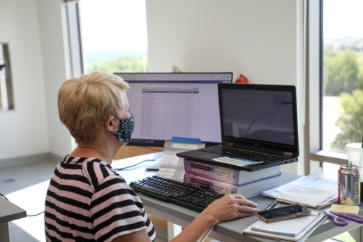 Woman with mask at desk
