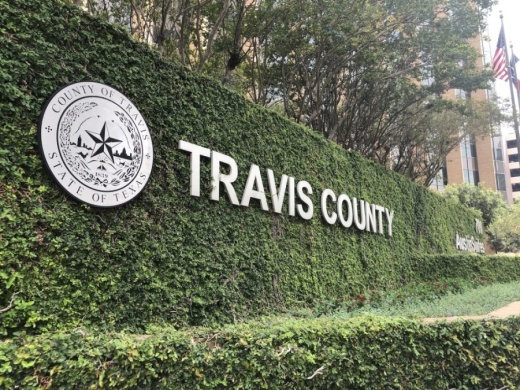 Photo of a sign that says "Travis County"