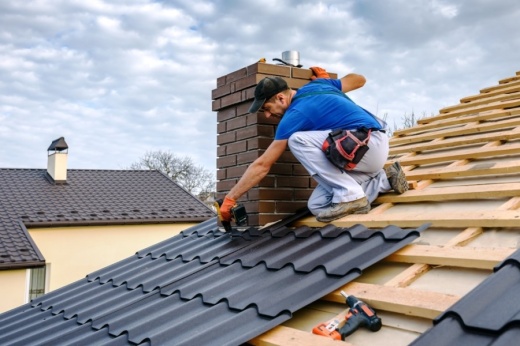 A man installing new roof tiles