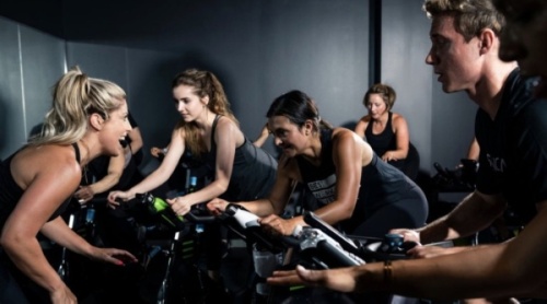 People participating in a spin class