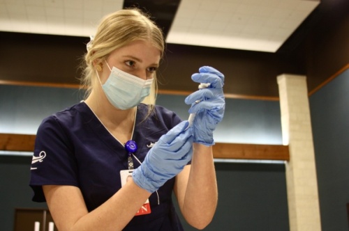 Hannah Sullivan, a Galen College of Nursing student, prepares a Moderna vaccine during a January vaccine clinic in Comal County. (Lauren Canterberry/Community Impact Newspaper)