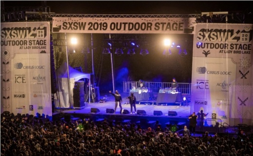 Photo of two performers on an outdoor SXSW stage