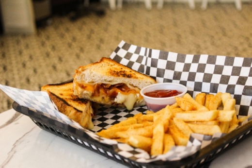 The Not Your Mama’s Grilled Cheese ($8.95) is made with four types of cheese and served with fries. (Photos by Adriana Rezal/Community Impact Newspaper)