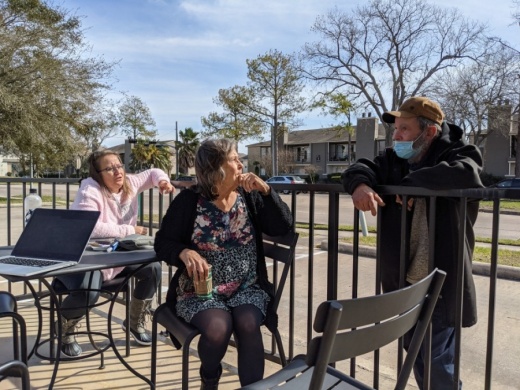 Janice Rains-Moran (center) and her daughter Danielle Rains speak in late January with Troy, one of the many homeless people who live in Clear Lake. (Jake Magee/Community Impact Newspaper)