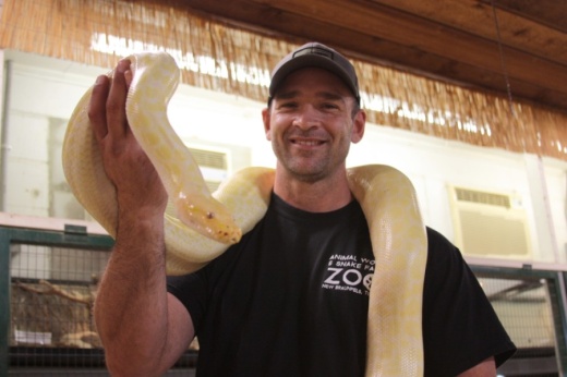 Jarrod Forthman holds a Burmese Python, one of several the zoo houses. (Lauren Canterberry/Community Impact Newspaper)
