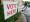 Photo of signs saying "Vote Here" and "Vote Aqui"